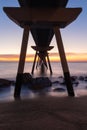 View from below the oil bridge with a sunrise on the horizon